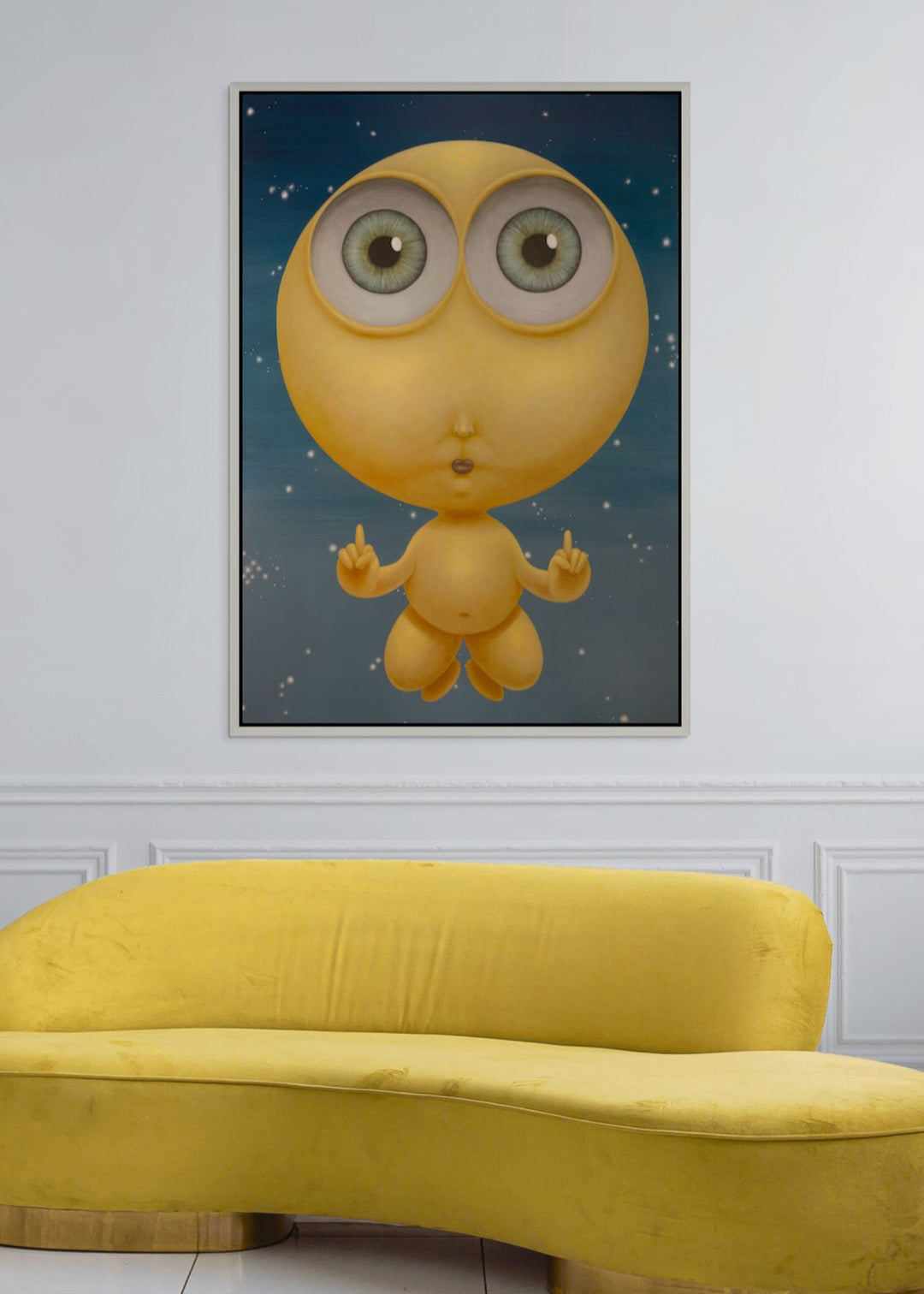 Yellow sofa in front of a wall with a framed illustration of a cartoon character.