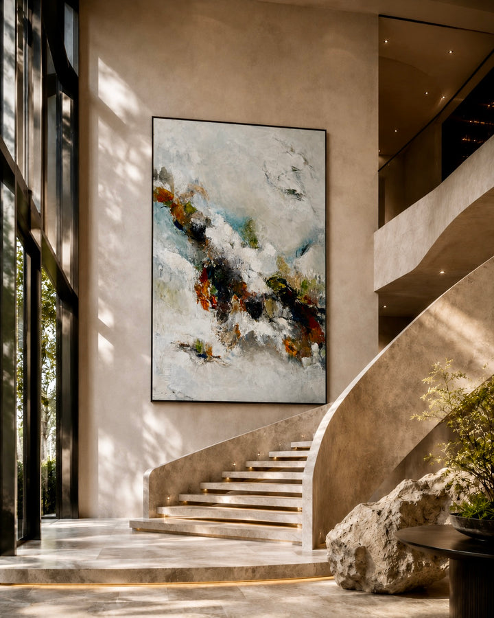 Abstract painting on a wall in a modern interior setting with stairs and decor.