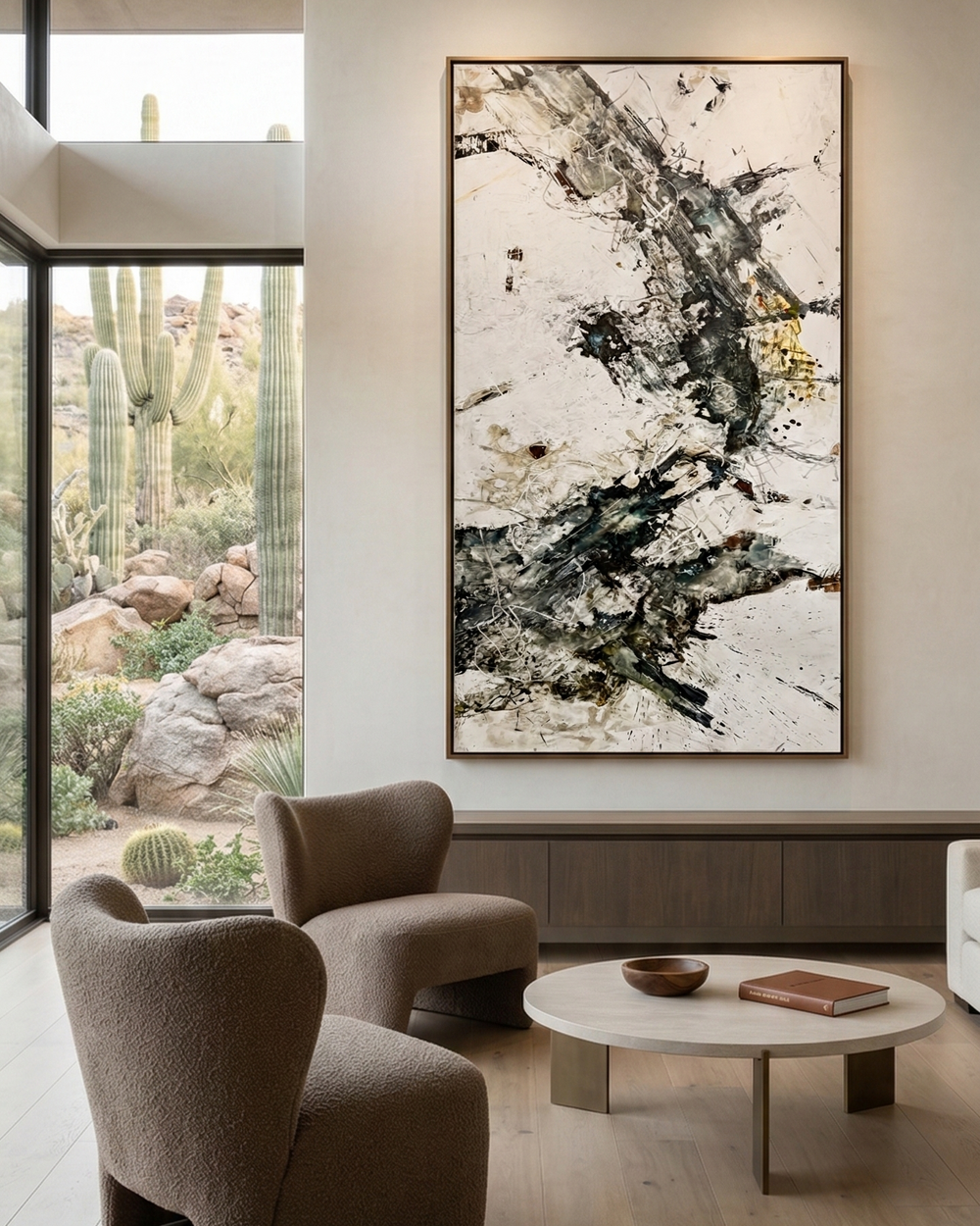 Modern living room with abstract art on the wall, furniture, and large windows.
