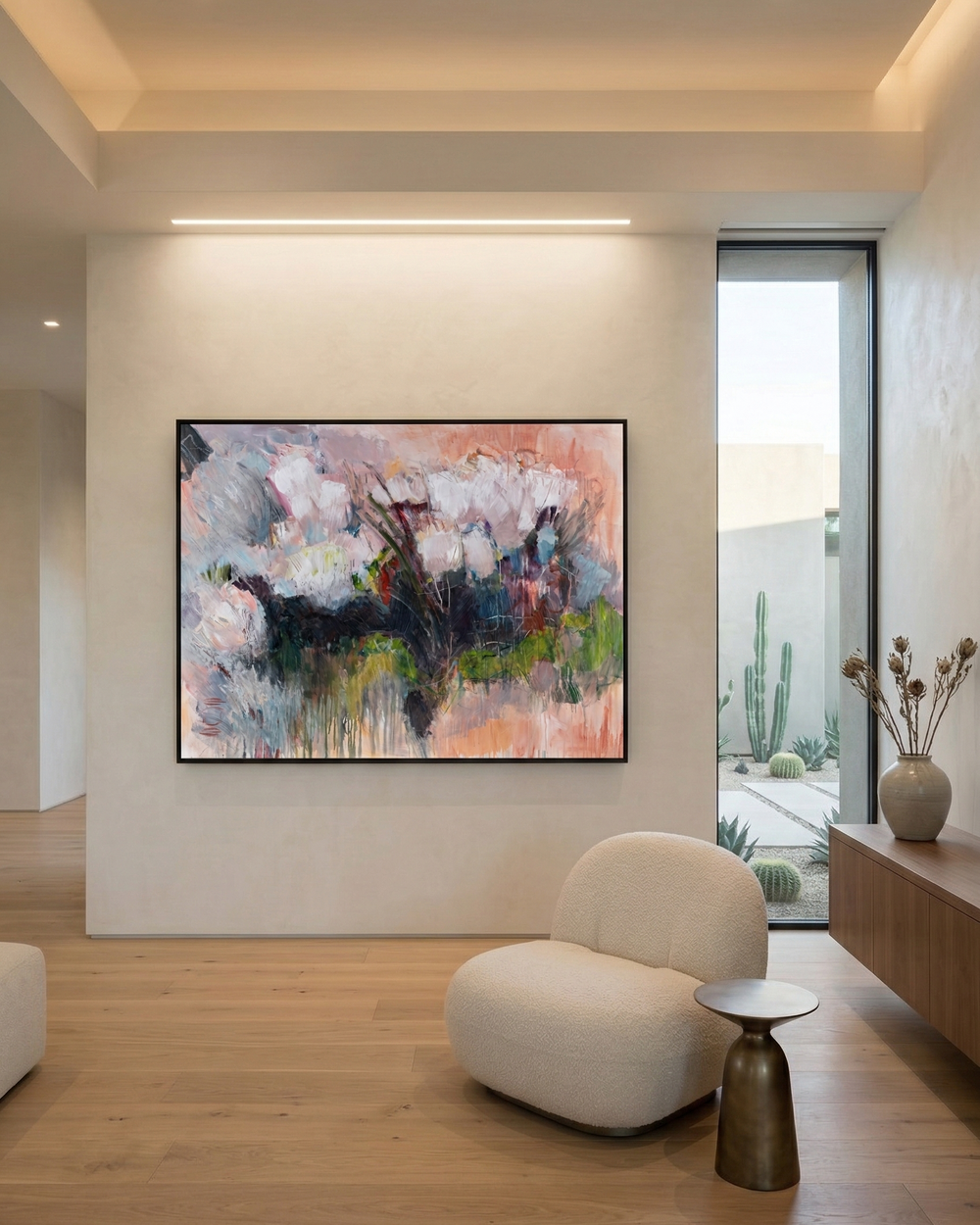 Modern living room with abstract floral painting on the wall, white armchair, and small table.