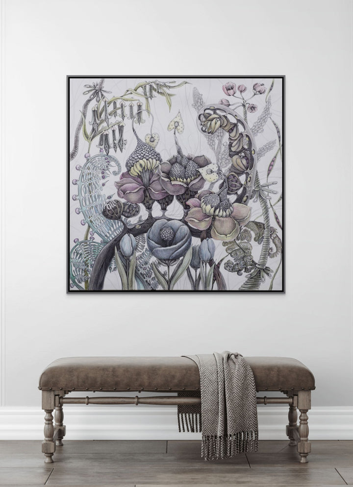 Decorative floral artwork on a white wall above a wooden bench with a blanket.