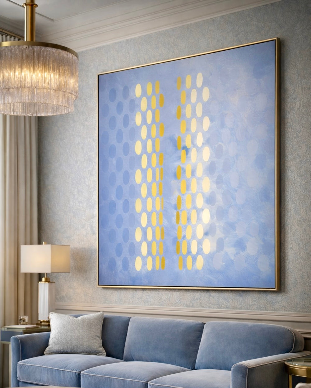 Living room with a blue sofa, abstract art on the wall, and a chandelier.