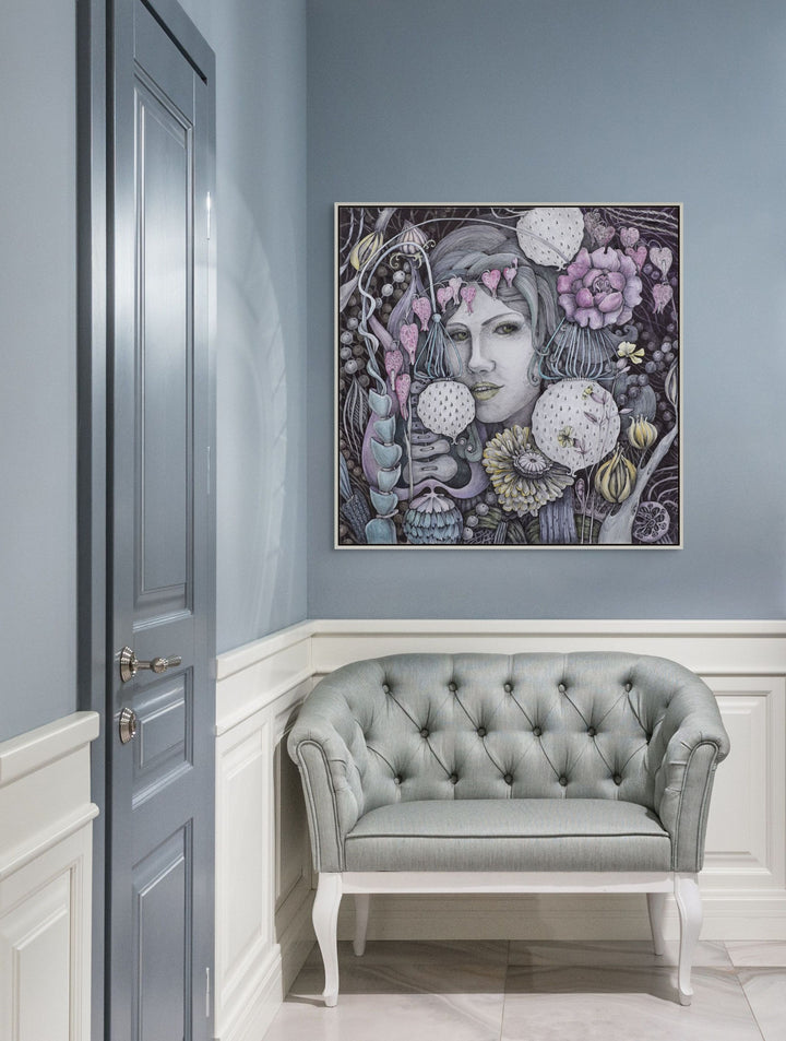 Decorative wall art above a gray tufted sofa in a room with light blue walls.