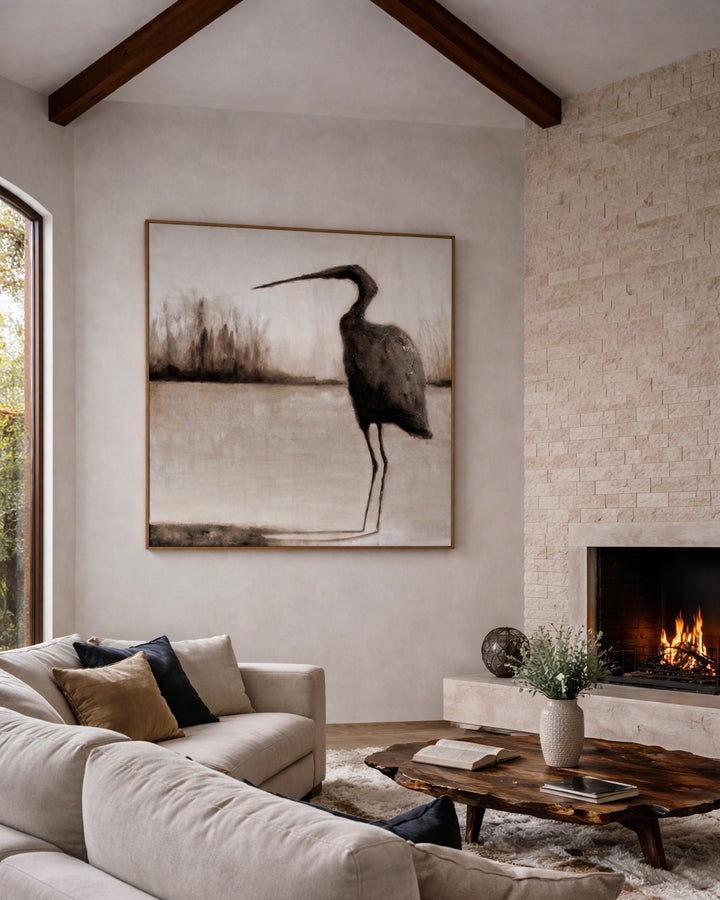 Modern living room with a large abstract painting of a bird, a fireplace, and a comfortable sofa.