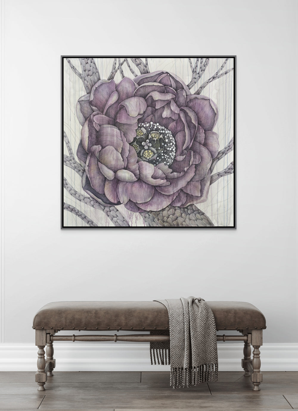 Framed artwork of a purple peony flower on a white wall above a wooden bench.