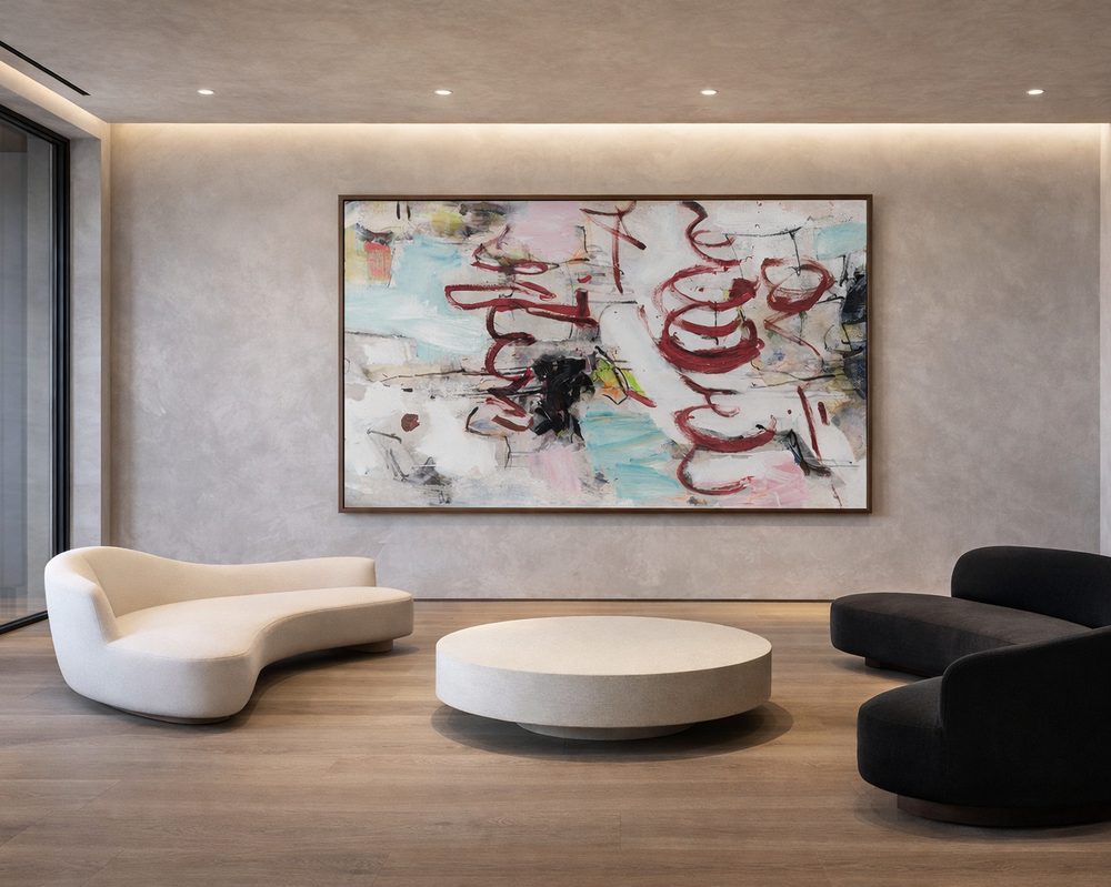 Modern living room with abstract art on the wall, white and black curved sofas, and a round coffee table.