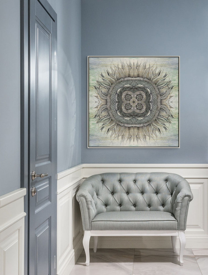 Gray tufted sofa in a room with a decorative wall art piece on a blue wall.