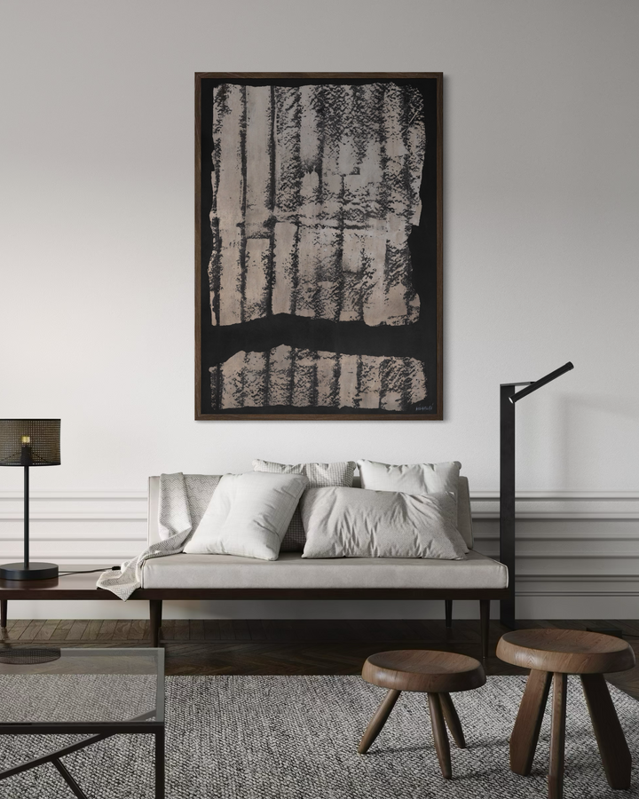 Modern living room with a sofa, coffee table, and abstract art on the wall.