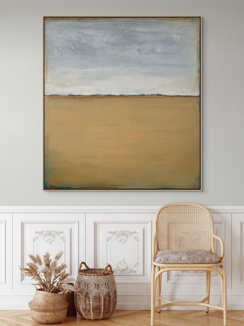 Square framed canvas print with muted blue and beige abstract landscape.
